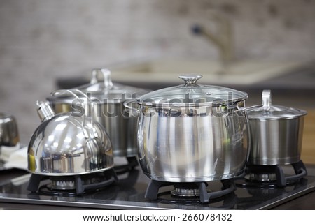 kettle, stainless steel pan on gas cooker