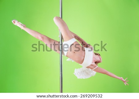 sexy girl in white shorts and angelic wings makes  element flat line at pole dance