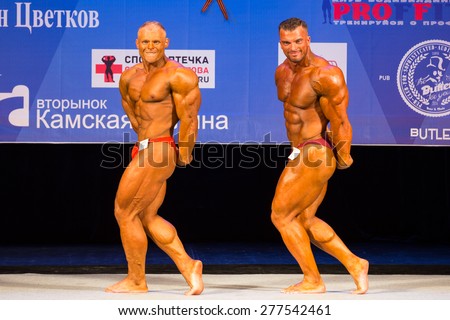 Perm, Russia - April 19, 2015.Cup Perm Krai  on bodybuilding and fitness bikini. Two bodybuilder show triceps