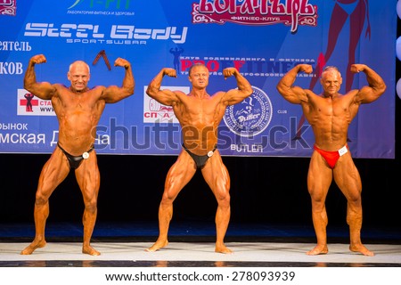 Perm, Russia - April 19, 2015.Cup Perm Krai  on bodybuilding and fitness bikini. Sun - Tanned bodybuilders in briefs show double biceps