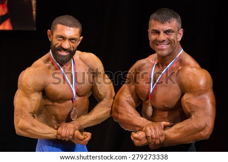 Izhevsk, Russia - April 18, 2015. Open championship of the Volga Federal District of bodybuilding and fitness bikini. Portrait of a bodybuilder with a beard and a medal