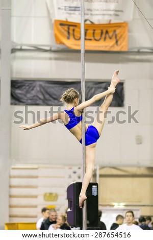 Perm, Russia - April 25, 2015. Championship Perm region at pole sport and dance. Child in blue shorts and top doing item ballerina