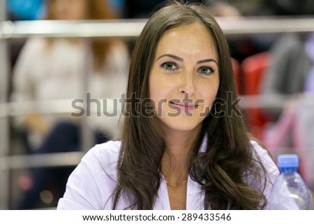 Perm, Russia - April 25, 2015. Championship Perm region at pole sport and dance. Judge brunette woman with long hair in the competition on pole sport