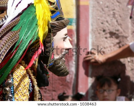 Masked dancer during fiesta of San Miguel