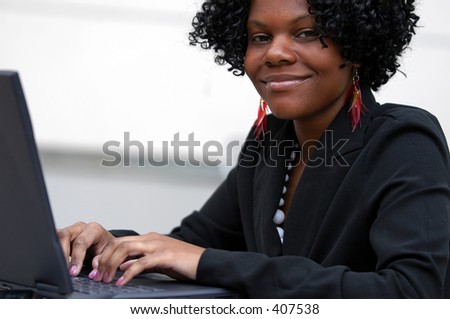 Lady smiles as see types on the computer