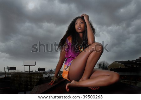African American woman thinking as she stares, as she leans on her arms