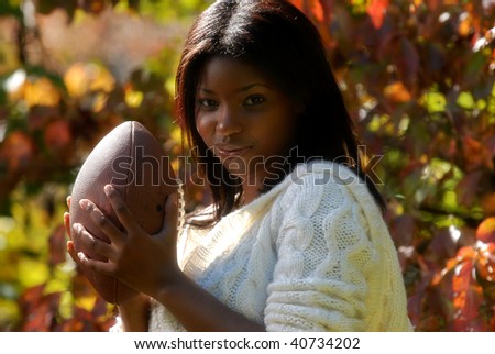African-American woman with a football