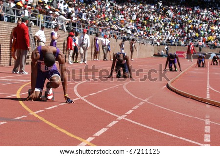 PHILADELPHIA, PA - APRIL 29: Unidentified college men runners ready to start relay race on Saturday, April 29, 2006 in Philadelphia. This is the 112th Penn Relays at the University of Pennsylvania\'s Franklin Field