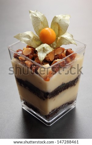 Tiramisu with crushed roasted nuts in glass cup