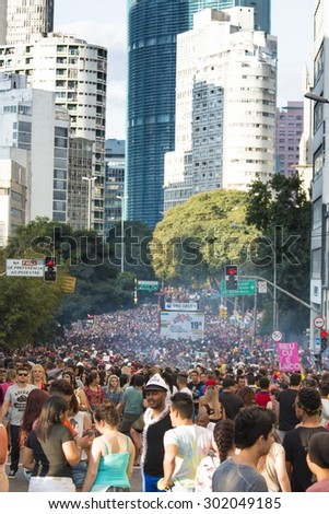 SAO PAULO, BRAZIL - June 7, 2015: crowd at the gay parade, with building the center of the city in the background, in the 19th Gay Pride Parade Sao Paulo