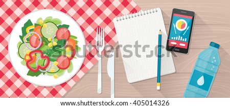 Food, diet, healthy lifestyle and weight loss banner with a dish of salad, table set, smartphone and diet plan on a notebook