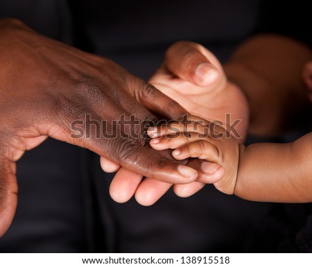 An african family\'s hands coming together