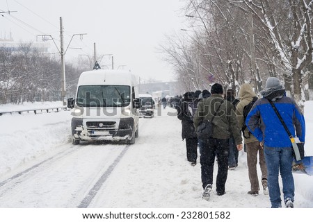 BUCHAREST - FEBRUARY 13 : Heavy snowfall of nearly 60 cm (2 feet) on February 13, 2012 has paralyzed the traffic. People left their cars and are walking on the road.
