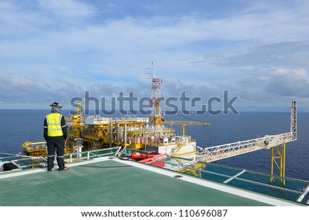 The helicopter landing officer is on the oil rig platform in the gulf of thailand.