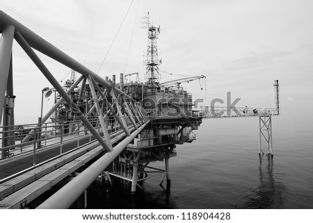The black and white offshore oil rig in the gulf of Thailand.