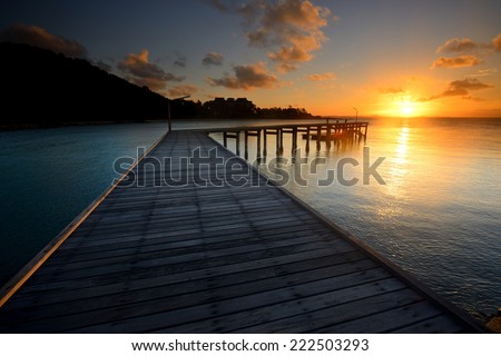 The landscape of beautiful wooden bridge with sunrise in the morning