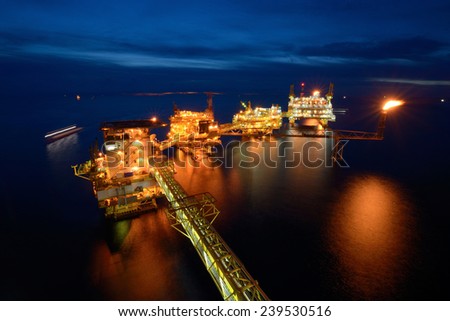 The large offshore oil rig platform at night in the gulf of thailand