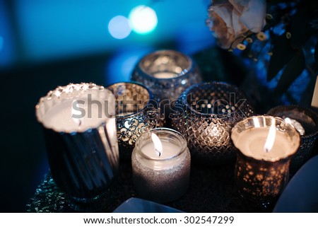 Luxury, fashion wedding decoration wedding, wedding table, restaurant. Candles, glasses, glare, color close-up. Wedding ceremony in the winter.