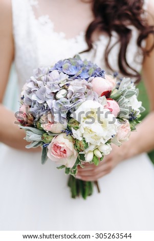Wedding bouquet for the bride.The beauty of flowers. Close-up of a bunch of flowers and wedding rings on a pillow. Wedding accessories. Female jewelry for girls. Details for the marriage of the couple