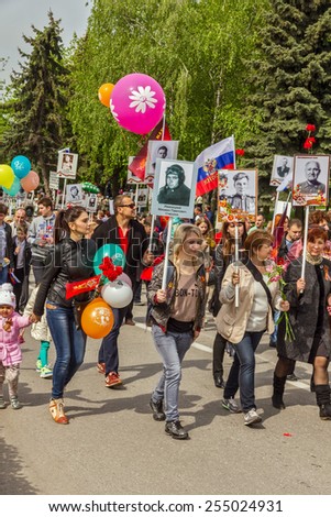 Pyatigorsk, Russia - May 9, 2014: A festive demonstration dedicated to the to Victory Day. Pyatigorsk. People with portraits of relatives who had fought are on the streets.