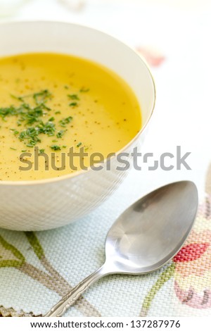 Curry, coconut, butternut squash soup in a bowl.