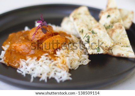 An Indian food dish of tikka masala and basmati rice.