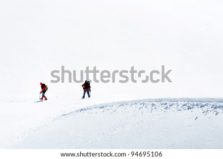 Team of alpinists climbing a mountain