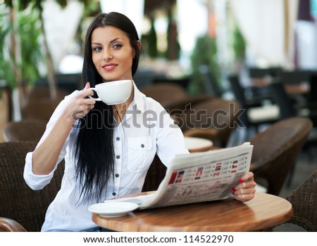 Young girl reading a newspaper during the job break