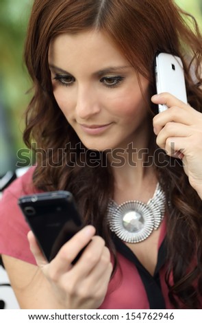 Young brunette girl using the mobile phone