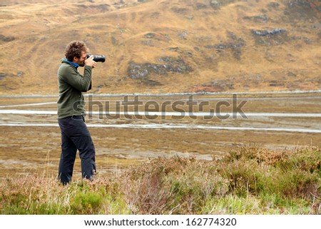 Nature photographer in the ourdoors, Highlands, Scotland, Europe
