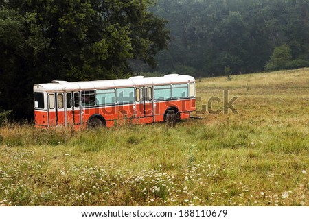 Abandonned bus at the edge of a forest