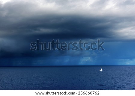 Boat on the Atlantic Ocean - stormy clouds in the background