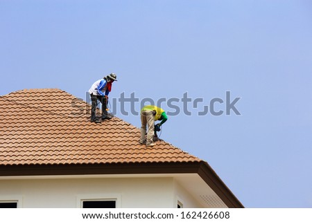 Workers Repair Concrete Roof Tile