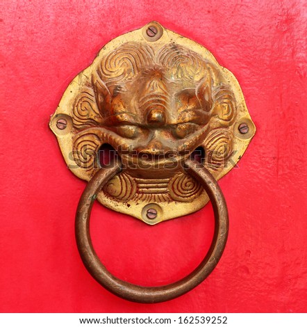 vintage door handle on red door Thai temple