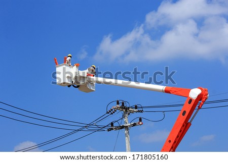Electricians  repairman  working  on  hydraulic platform