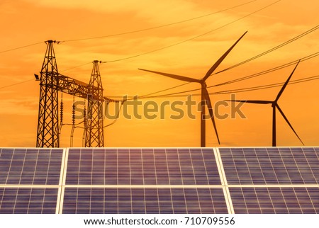 solar cells and wind turbines generating electricity with high voltage electrical power pylon in power station alternative renewable energy from the natural on sunset.
