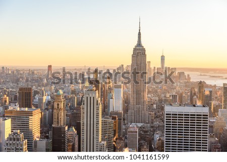 New York City - USA. View to Lower Manhattan downtown skyline with famous Empire State Building and skyscrapers at sunset.