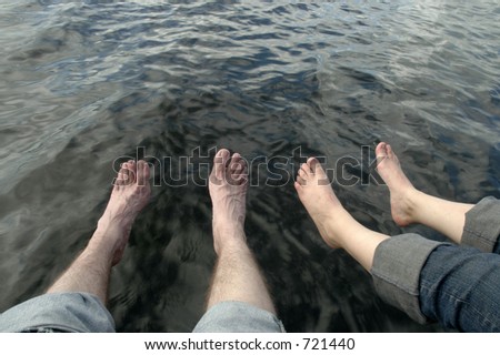 feet dangling over water