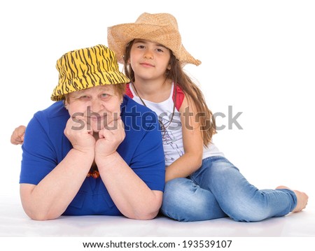 Grandmother and granddaughter on the floor in hats