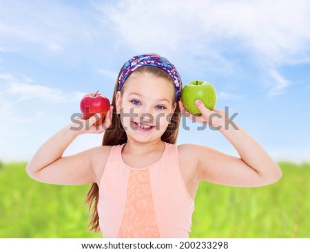 young girl holding two apples