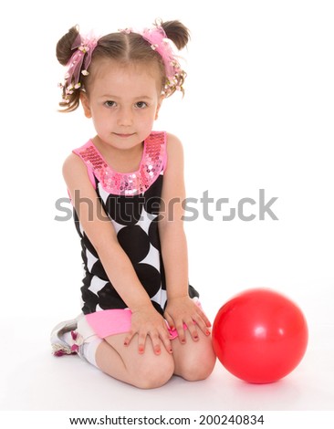 Charming little girl put her hands on her knees and looking into the camera. Isolated on white background