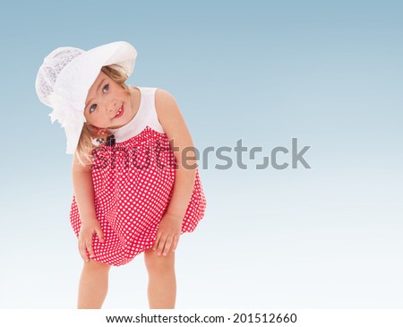 The girl in a hat and red dress with polka dots.child, happiness and people concept, lovely smiling toddler portrait