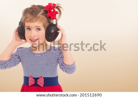 Portrait of a girl in the headphones.child, happiness and people concept, lovely smiling toddler portrait