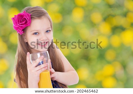girl with a red bow and a glass of orange juice.healthy food concept,active lifestyle,happiness concept,carefree childhood concept.
