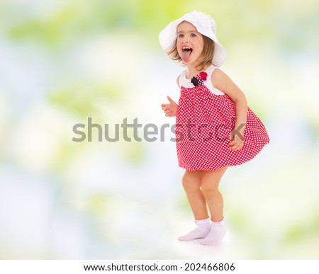 girl in red dress fun stuck out her tongue.cheerful summer holiday,active lifestyle,happiness concept,carefree childhood concept.