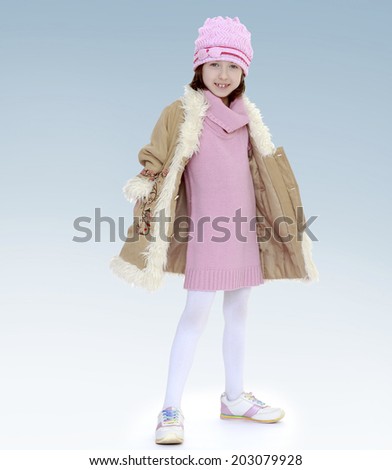 girl in coat and red hat.new year, warm clothing,happiness concept,happy childhood,carefree childhood,active lifestyle