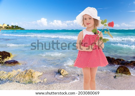 girl in red dress and white panama hat on sea background.floral bouquet, flowers delight,happiness concept,happy childhood,carefree childhood,active lifestyle