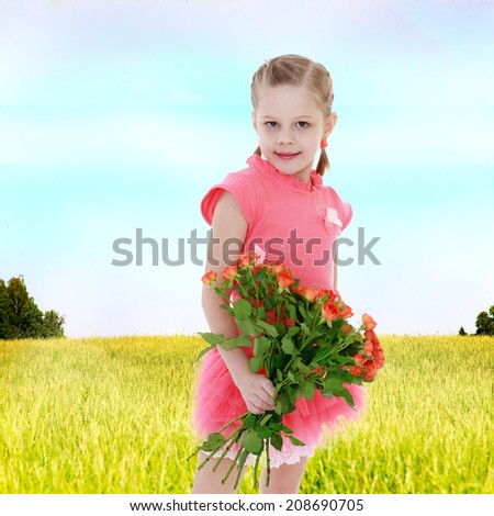 The girl in the field with a bouquet of flowers.Summer fun, the concept of happiness and family wellbeing.