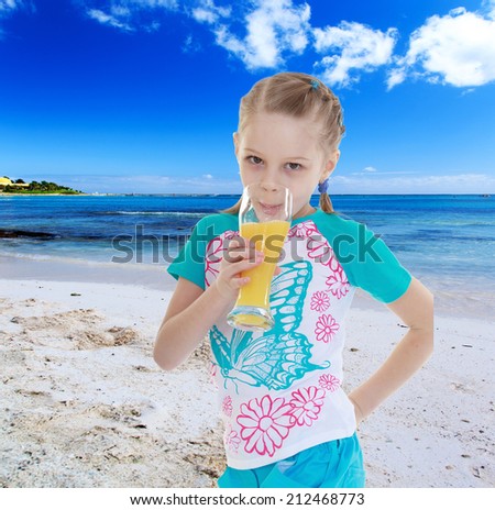 Charming girl loves to drink orange juice resting on the sea.