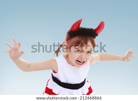 little girl put on a toy horn and scare your friends.The concept of child development, education, recreation